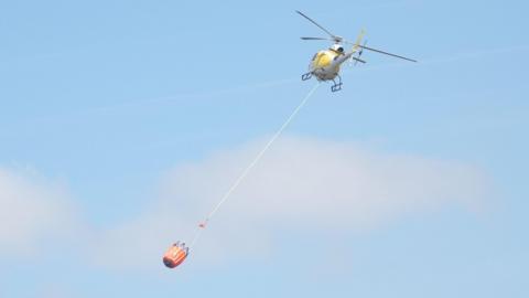 Helicopter deploying water