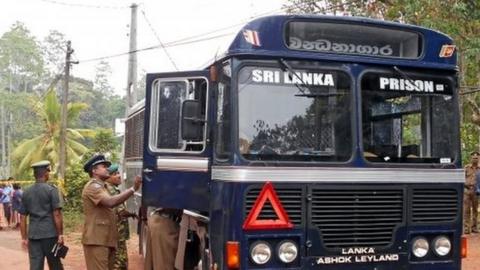 Sri Lankan police officers inspect a prison bus after gunmen opened fire in Colombo, Sri Lanka February 27, 2017.