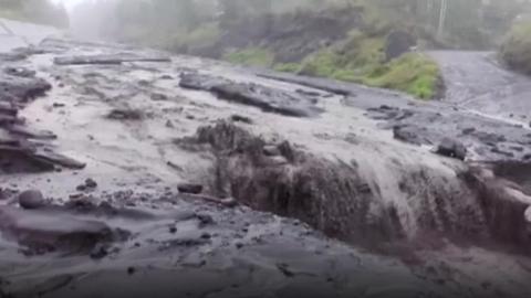 Mud flowing down a broken road