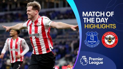 Nathan Collins celebrates with both arms stretched out in Brentford kit