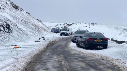Abandoned vehicles on an icy Peak District road