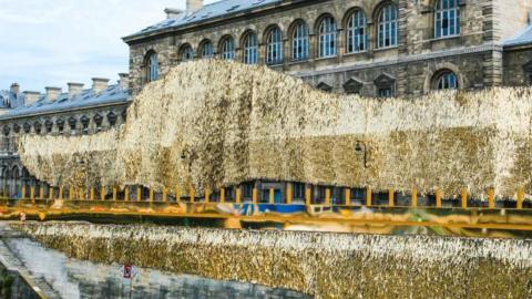 A building by the Seine covered in gold