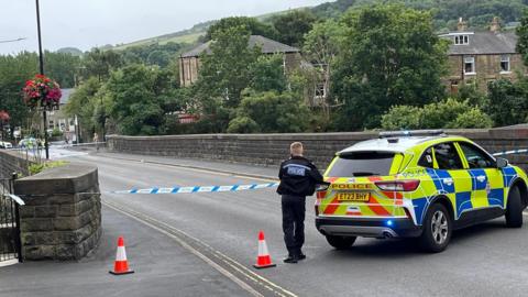 Police tape across the entry of the  Union Road Bridge 