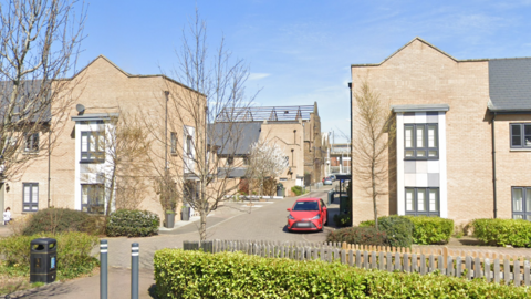 A Google Street image of a residential street with new-build homes either side.