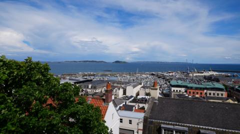 An aeriel view across Guernsey's St Peter Port looking out to the islands of Herm and Jethou.