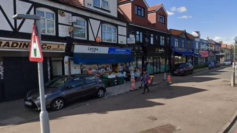 A general street view of a shopping precinct on Woodford Avenue.
