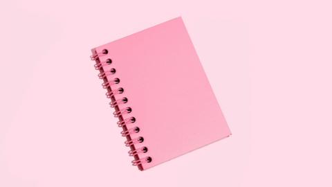 Pink Note Pad On Pink Background - stock photo
