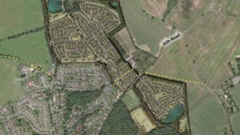 A proposed development site showing proposed homes on a number of fields.