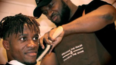 Wilfried Zaha getting his hair done by Nikky