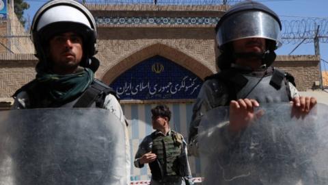 Afghan riot police stand guard outside the Iranian consulate during a protest against the Iranian regime and demand justice for the Afghans allegedly killed by the Iranian security forces, in Herat, Afghanistan, 11 May 2020