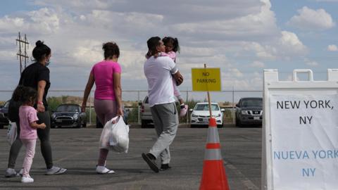 Venezuelan Frederick Pinango, 28, walks with his three-year-old daughter Freyderlinck and his wife Julianis Contreras, 23, to board their bus to New York at the Migrant Welcome Center managed by the city of El Paso and the Office of Emergency Management, in El Paso, Texas, U.S