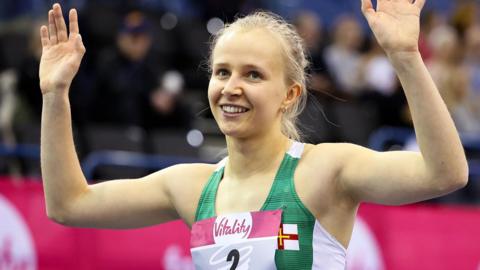 Abi Galpin raises her arms in celebration