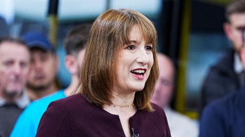 A photograph of Rachel Reeves in a purple dress