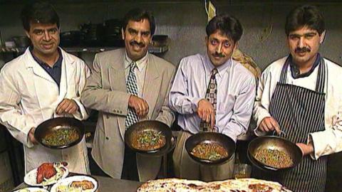 4 owners of the Punjab Paradise holding dishes containing food
