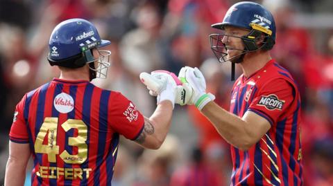 Jos Buttler celebrates with a fist bump with Tim Seifert