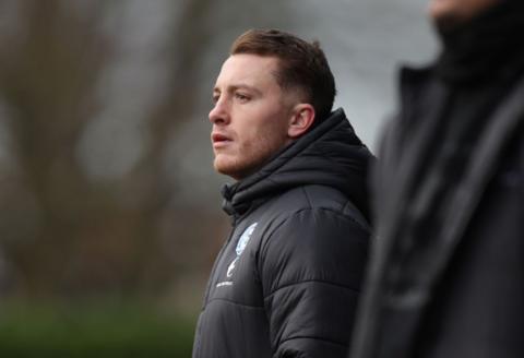 Dan Lawlor watches a match from the touchline