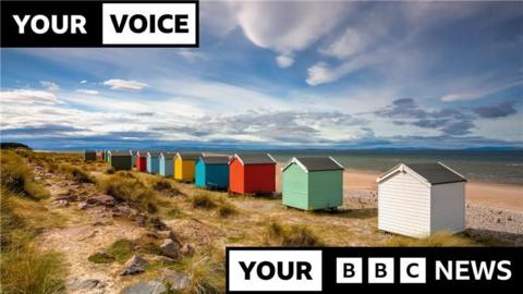 Colourful beach huts on the shore at Findhorn beach.