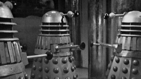A black and white still of three daleks from a Doctor Who episode