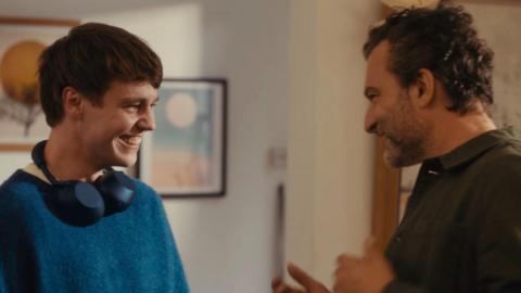 A son and father looking at each other and smiling in the John Lewis advert