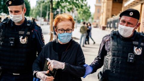 Photojournalist Viktoria Ivleva is led away by police outside the interior ministry in Moscow