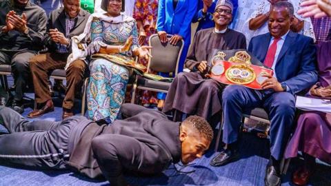 Anthony Joshua prostrating before Muhammadu Buhari