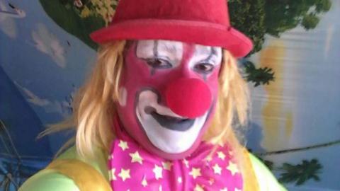 Clown poses for a selfie
