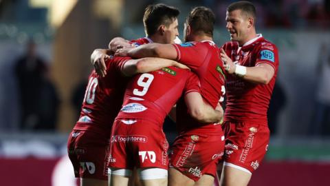 Scarlets players celebrate against Cardiff