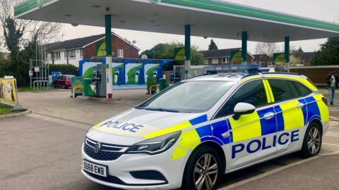 A police car parked at the petrol station in Cambridge