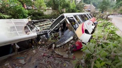 Buses on their sides in mud in Petrópolis, Brazil