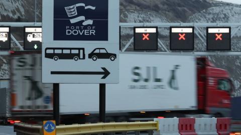 Lorry drives past sign at Dover