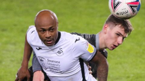 Andre Ayew of Swansea City holds off the challenge from Liam Shaw of Sheffield Wednesday