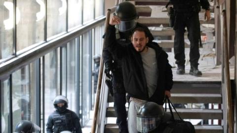 Spanish rapper Pablo Hasel reacts as he is detained by riot police inside the University of Lleida