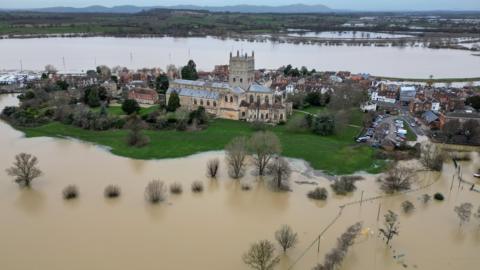An aerial shot showing the town of Tewkesbury surrounded by flood water