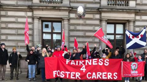 Members of IWGB holding Fairness for Carers banner