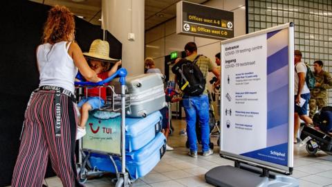 Traveller walking towards the test area at Schiphol airport 13 August