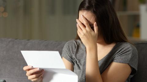 A woman upset at reading a letter
