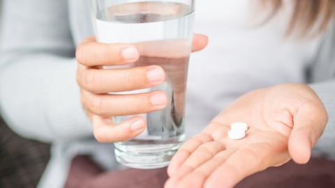 A woman taking pills