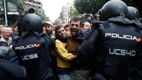 Spanish police and protesters in Catalonia