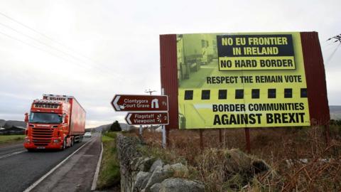 A lorry passes and anti-Brexit sign on a road close to the Irish border