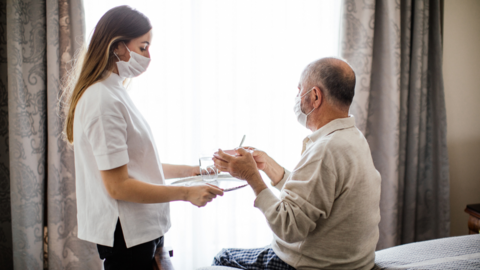 Care home worker helps resident