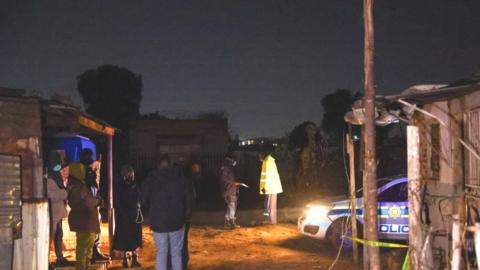 Police inspect the scene of a suspected gas leak in Boksburg's Angelo shanty town. Photo: 6 July 2023