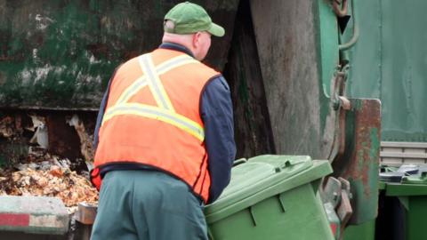 Stock photo of bin collection worker