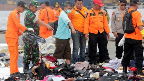 Rescuers stand with personal belongings of passengers on the flight - 31 October