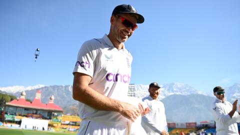 England bowler James Anderson smiles as he walks off the field after taking his 700th Test wicket