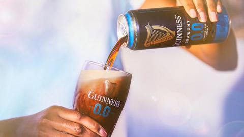 A can of Guinness being poured