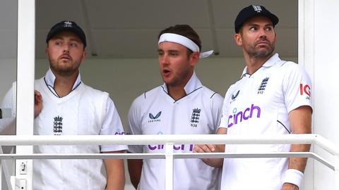 England players watch the rain