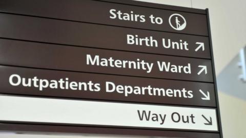 A sign for the Birth Unit, Maternity Ward and Outpatients Department