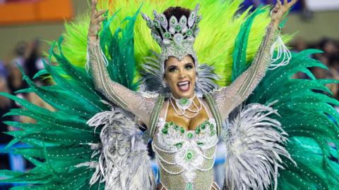 A member of Imperio Serrano Samba School gesturest during their parade at 2019