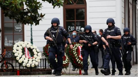 Police officers walk at the site of wreath laying ceremony e in Vienna, Austria November 3, 2020