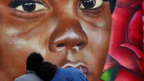 Two people visit a mural of Breonna Taylor in Colorado on 8 August 2020